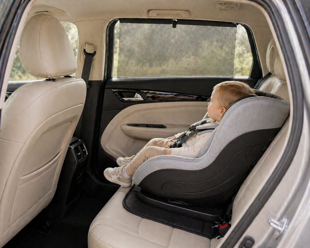 Car sunshade fitted to rear passenger window inside a bright modern car interior