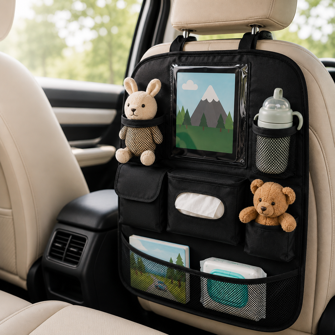 Black car seat back organiser attached to the rear seat, holding baby travel essentials including toys, wipes and a drinks bottle.