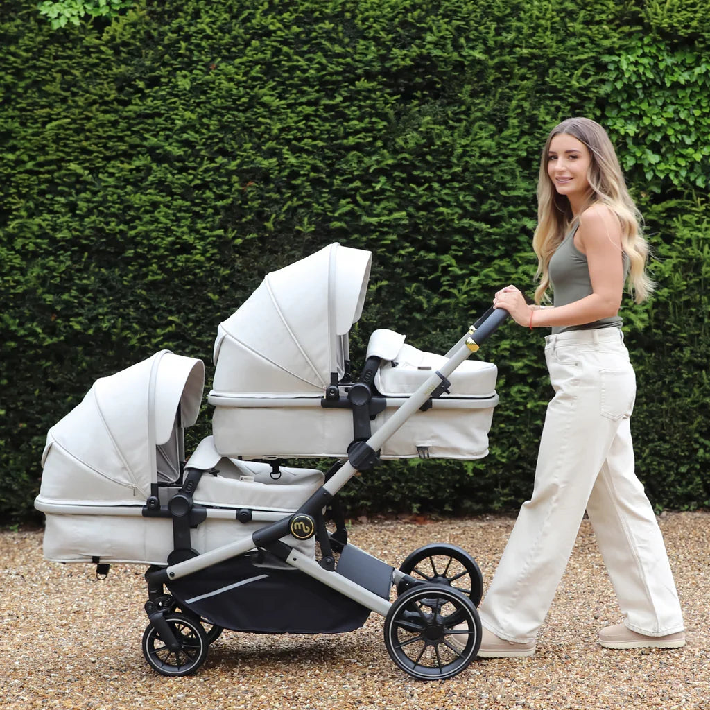 My Babiie MB33 tandem travel systems featuring double seating for two children, available in Black Leopard, Giraffe, Ivory and Rose Gold Black.