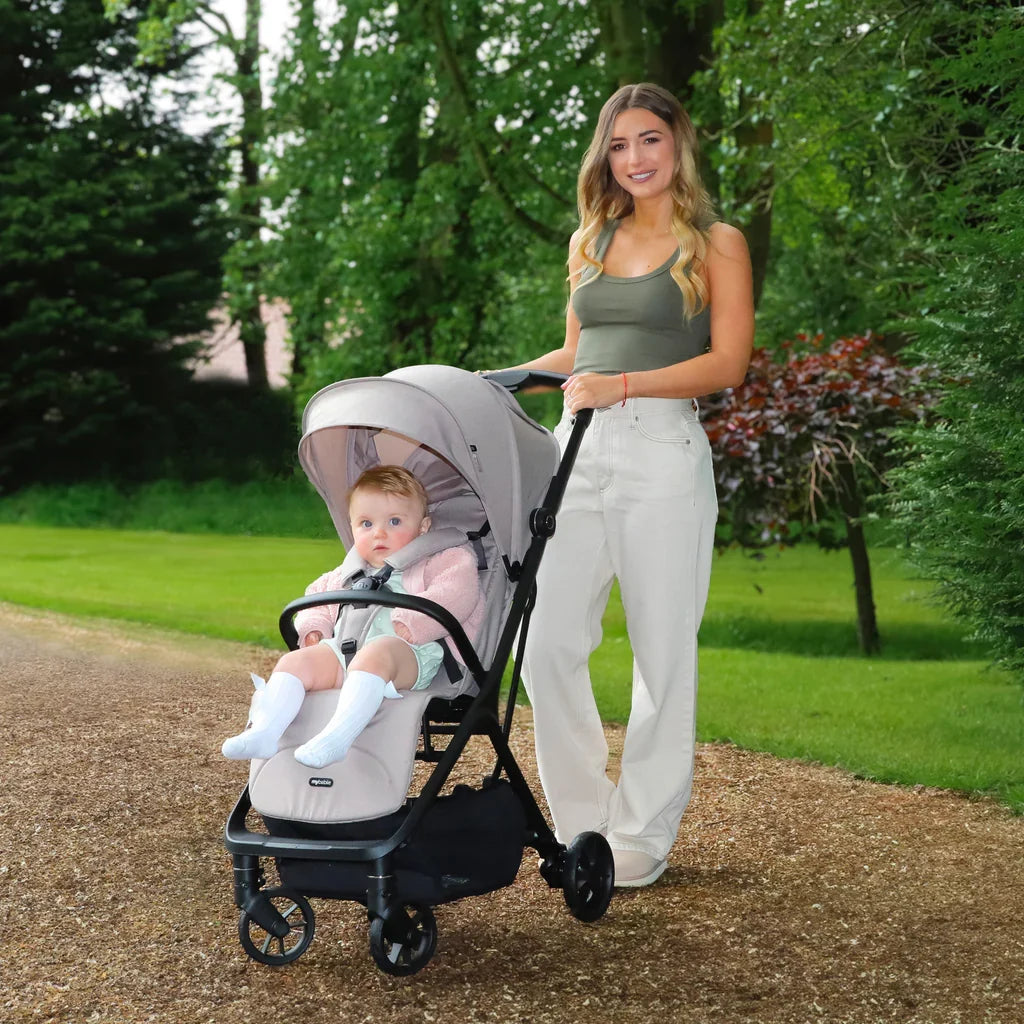 My Babiie MBX7 compact stroller featuring automatic folding, a reclining seat, XL UPF50+ sun canopy and all-wheel suspension, suitable from birth to 22kg.