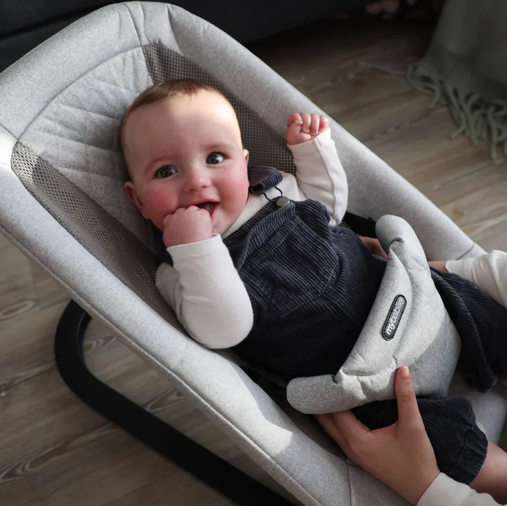 Baby nursery setup featuring bouncer, travel cot, playpen, and changing unit designed for comfort, safety, and everyday baby care