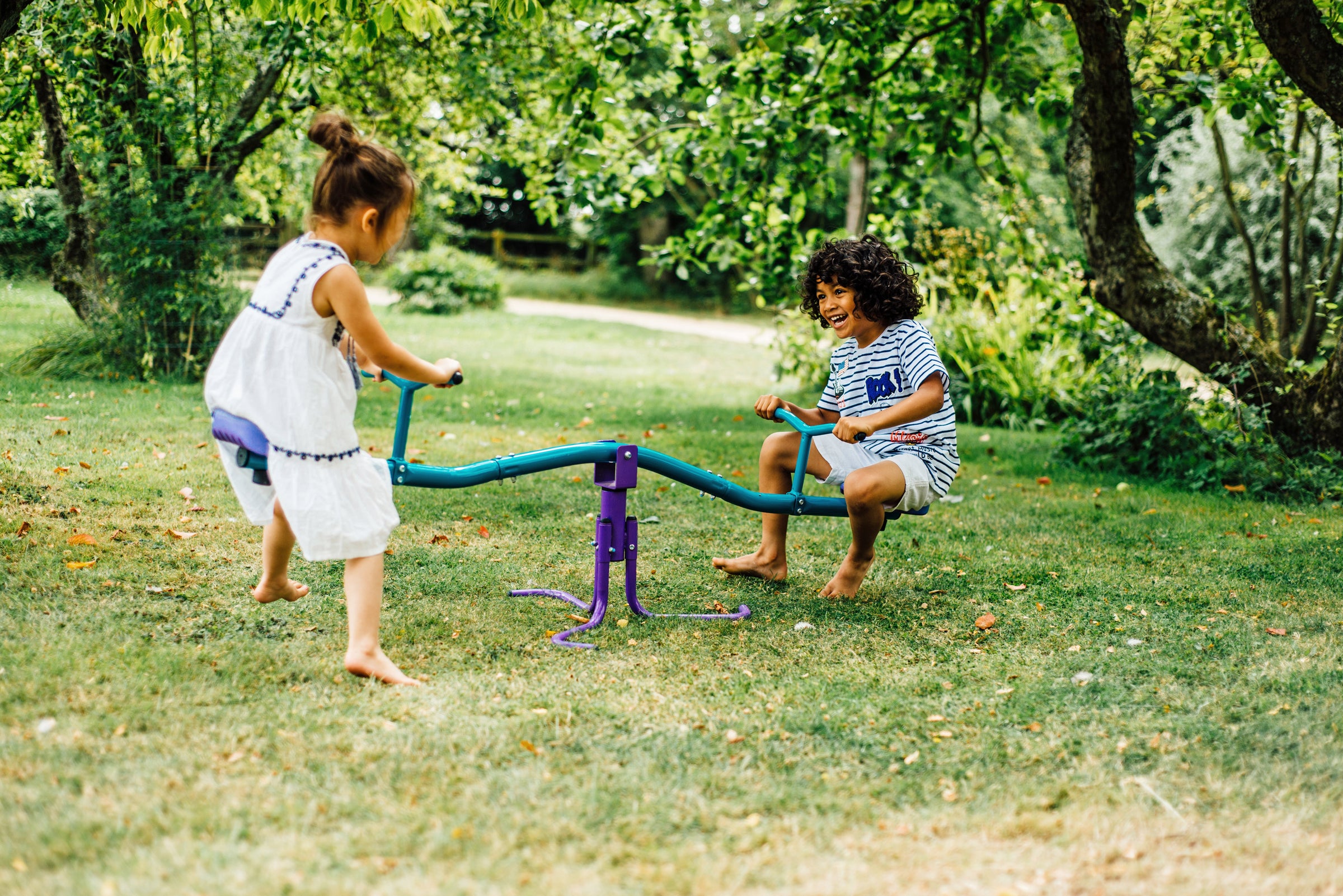Plum outdoor toys including playhouses, mud kitchens and activity towers in garden for kids play