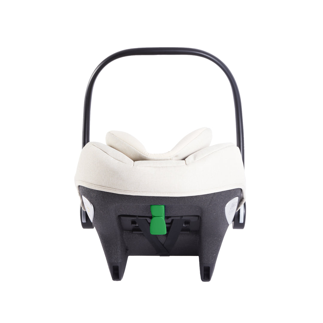 Baby car seat with white cushion and green strap on a white background