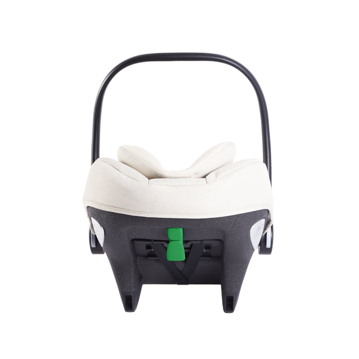 Baby car seat with white cushion and green strap on a white background