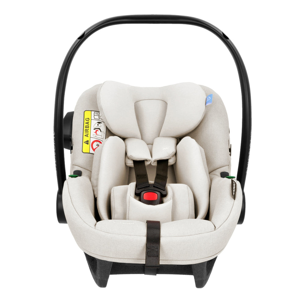 White baby car seat with black straps on a white background