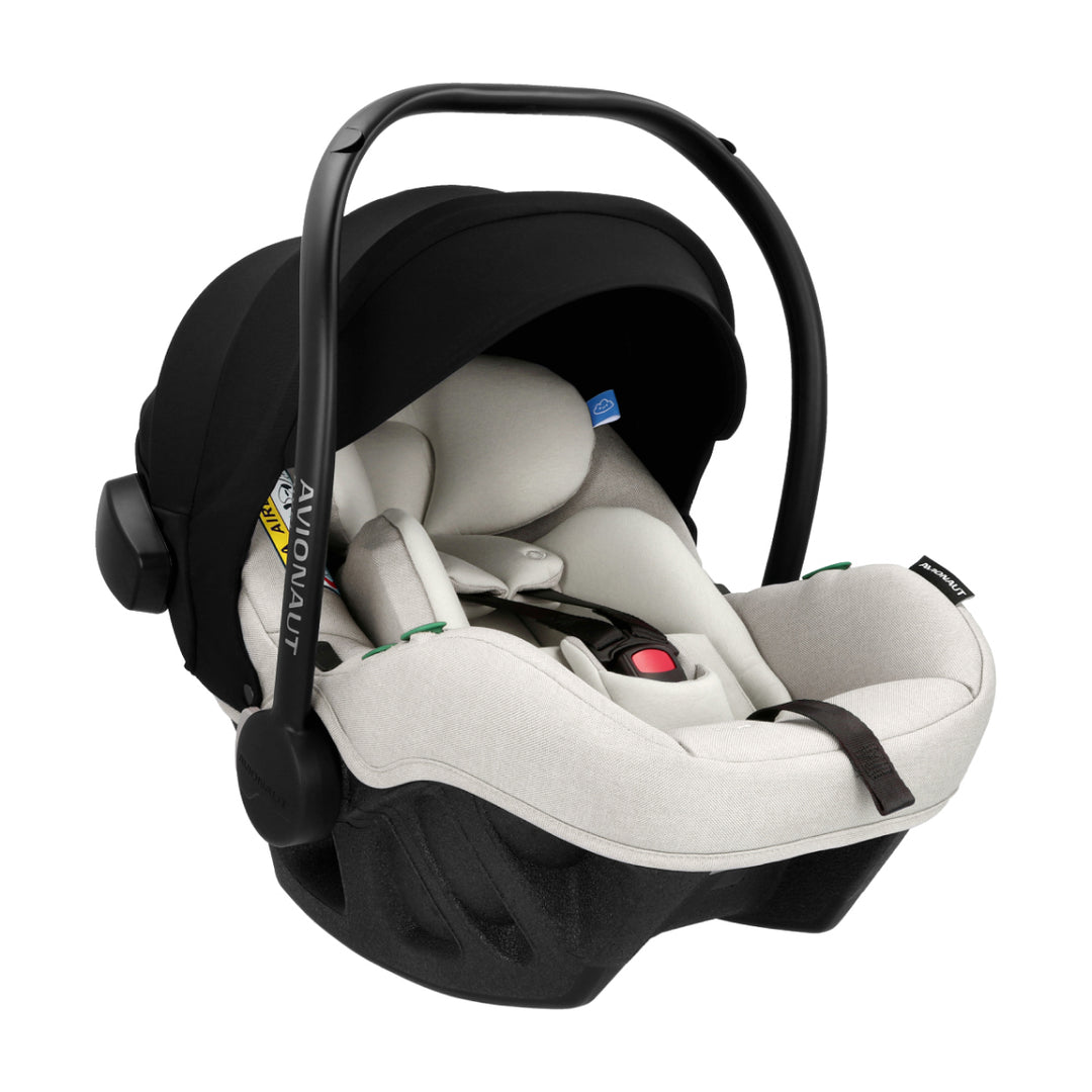 Baby car seat with black canopy and white seat on a white background