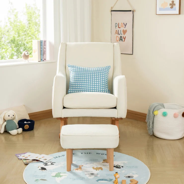 Off White nursing chair with a blue checkered pillow in a child's room with toys and a rug.