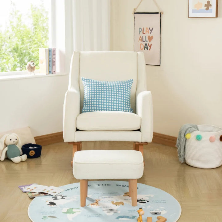 Off White nursing chair with a blue checkered pillow in a child's room with toys and a rug.