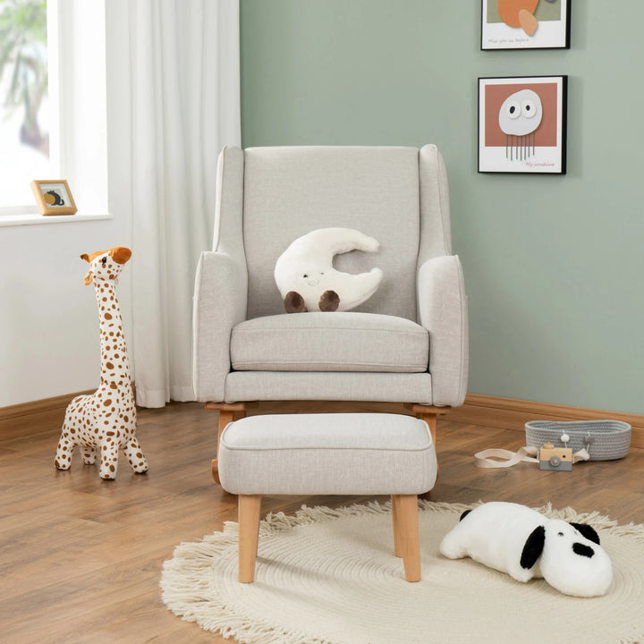 Cashmere armchair with a white cushion in a room with toys and framed pictures on the wall.