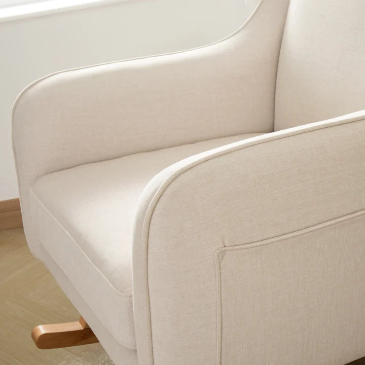Close-up of a beige sofa with wooden legs in a minimalistic setting