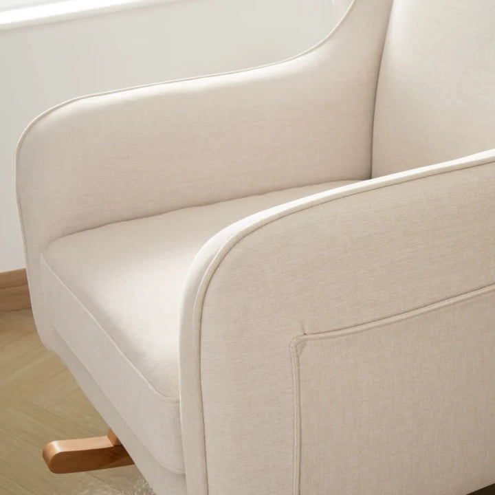 Close-up of a beige sofa with wooden legs in a minimalistic setting
