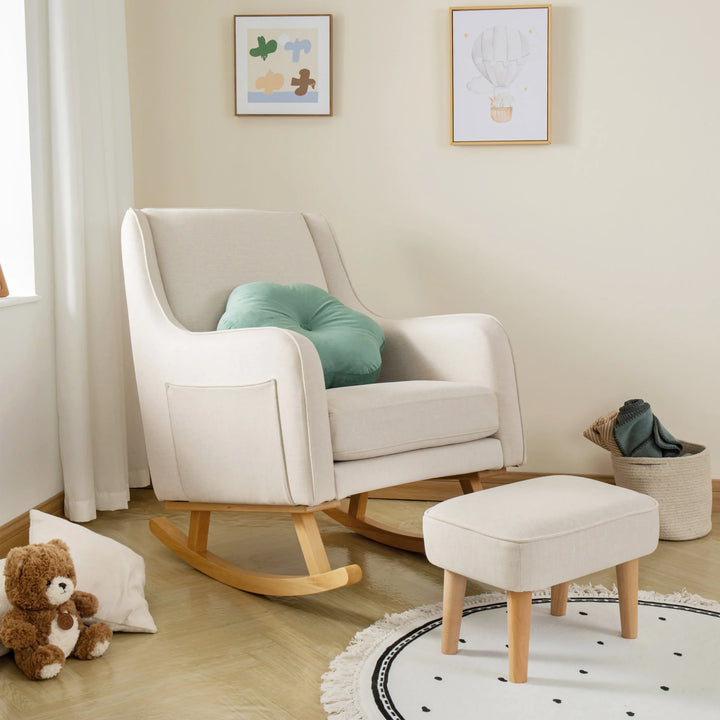 Ivory rocking chair with a green cushion in a nursery setting