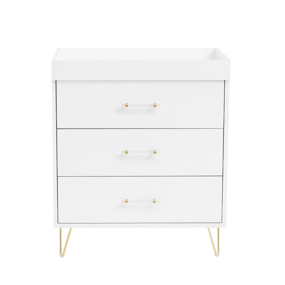 White dresser with gold legs and handles on a white background