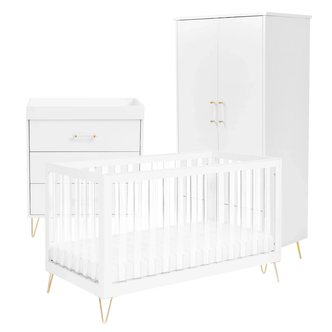 White crib, wardrobe and changing table set with gold legs on a white background