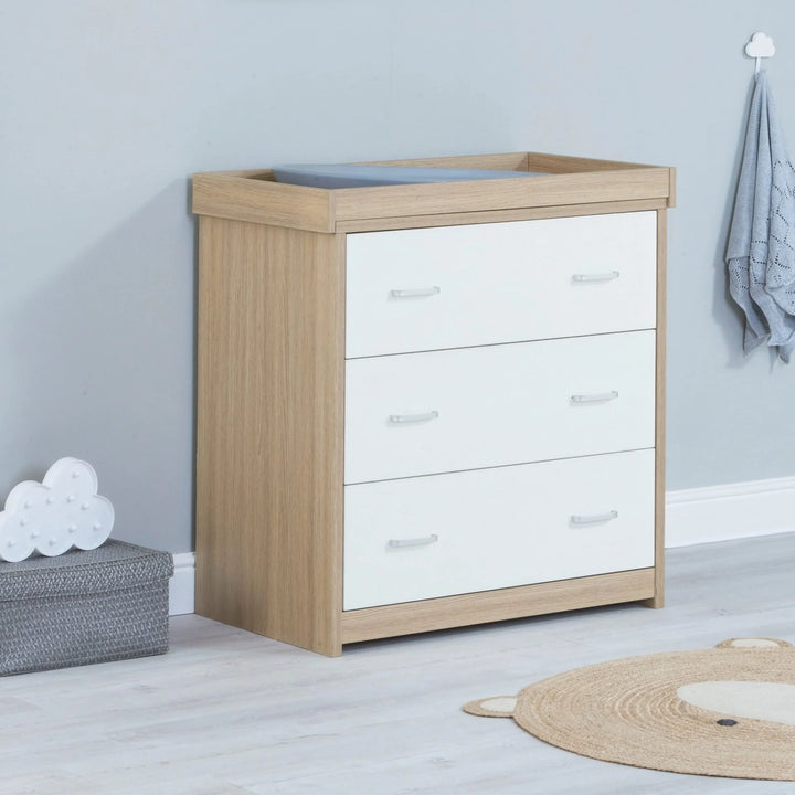 Wooden dresser with white drawers in a room setting