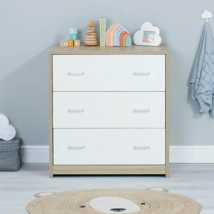 White dresser with wooden accents in a child's room with toys and decor.