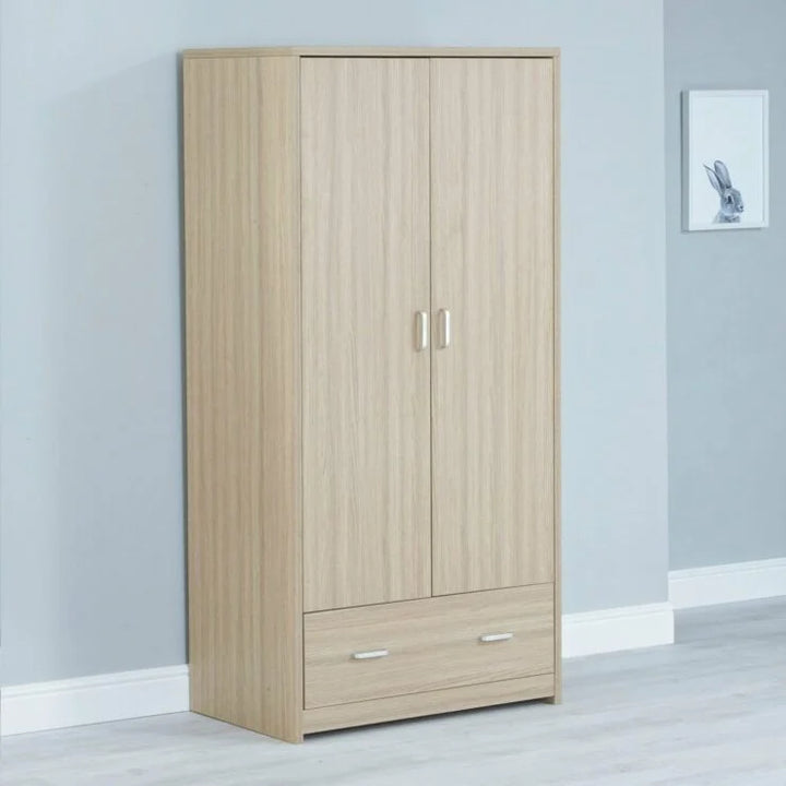 Wooden wardrobe with two doors and a drawer against a light grey wall.