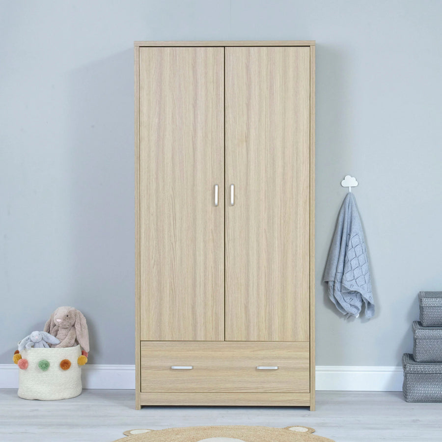 Nursery Wooden wardrobe with two doors and a drawer in a room setting.