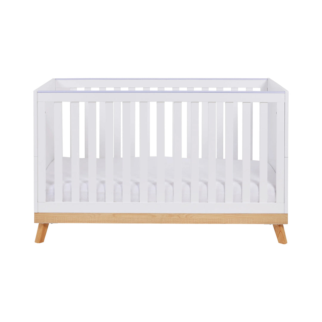 White crib with wooden base on a white background