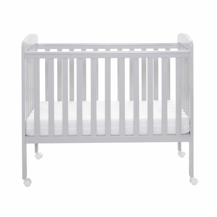 Grey crib with mattress on a white background