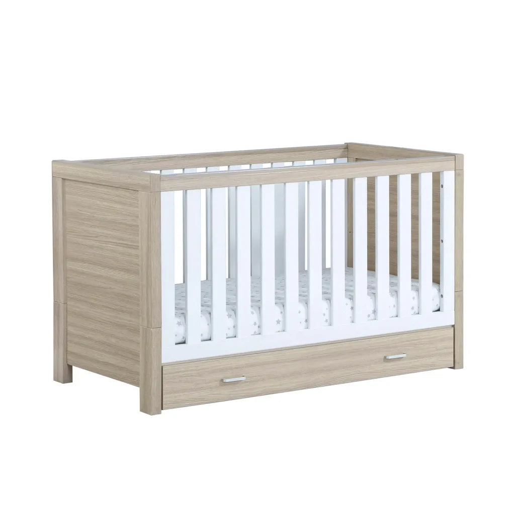 Babymore Luno White Oak Cot Bed with drawer on a white background
