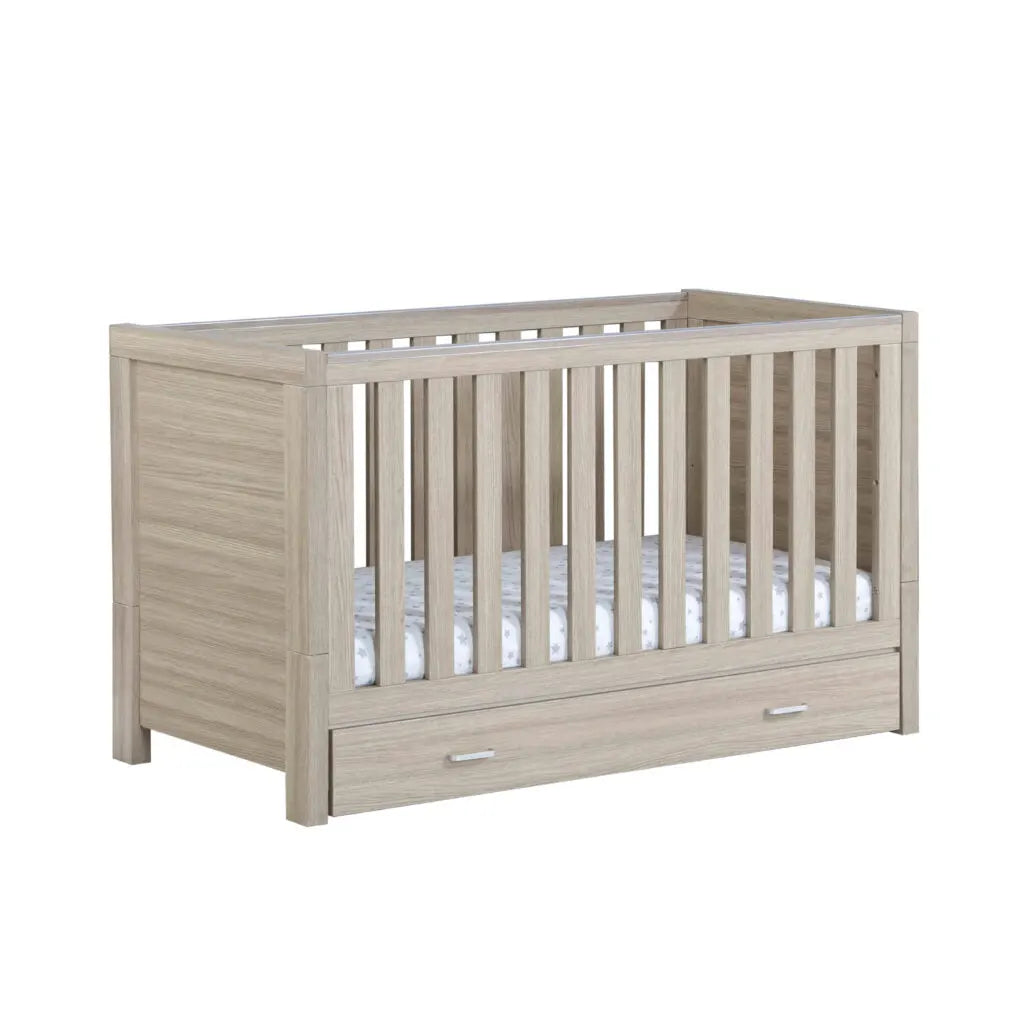 Babymore Luno Cot Bed with drawer in oak on a white background