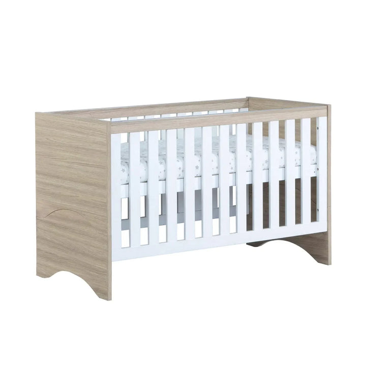 Babymore Veni Cot Bed White Oak with raised mattress on a white background