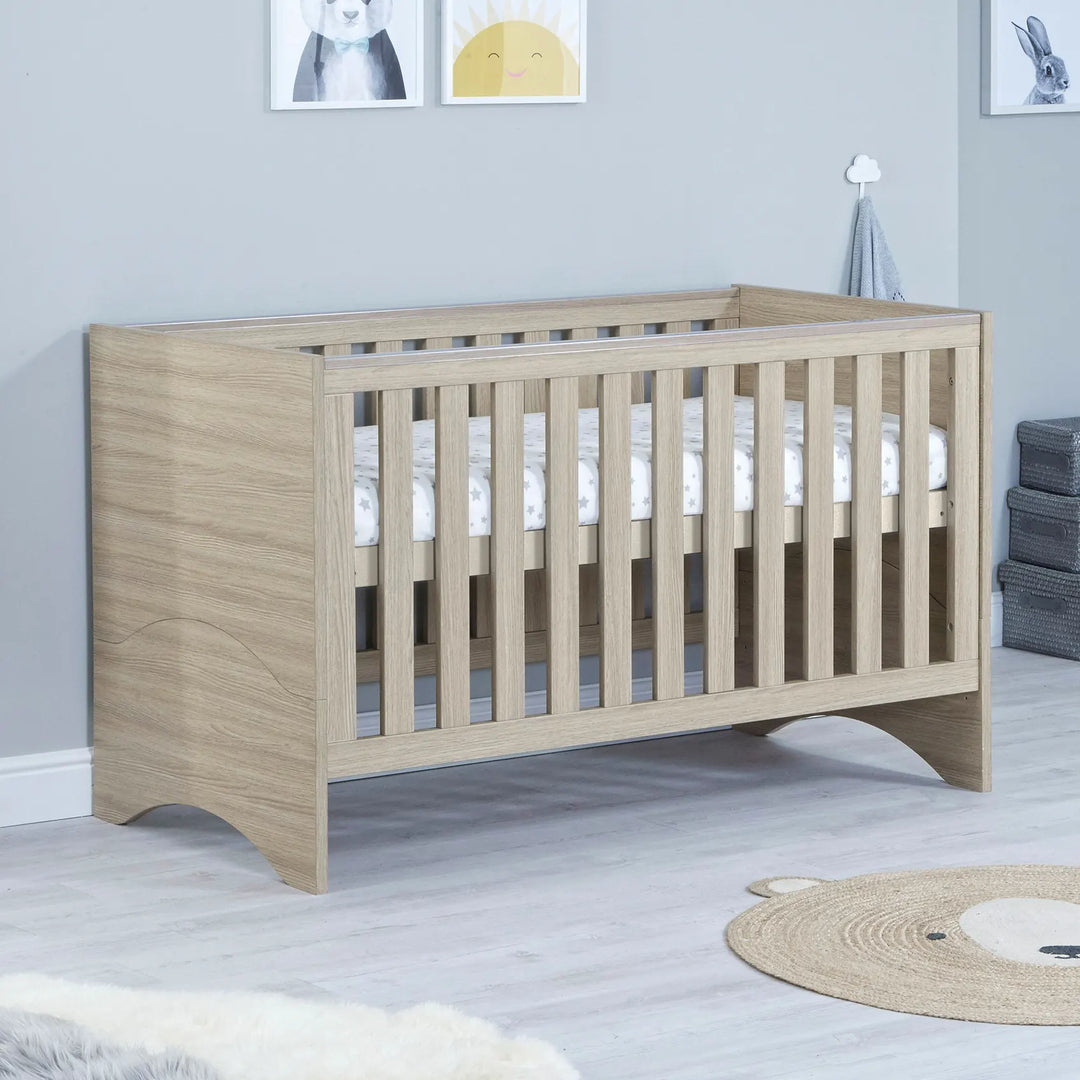 babymore Veni Cot Bed in Oak with raised mattress