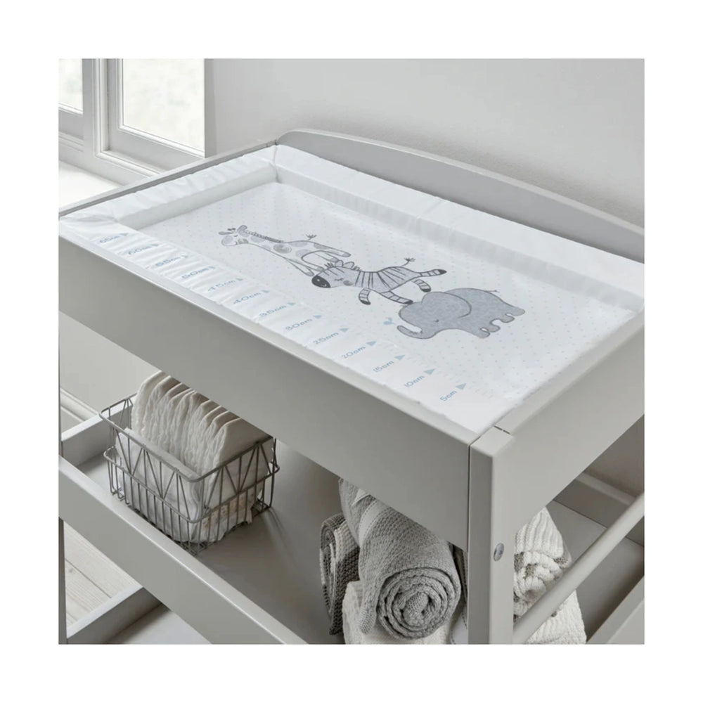 Grey changing table with a white cover featuring cartoon characters, placed against a light grey wall.