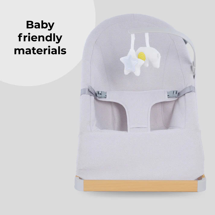 My Babiie Baby Bouncer with toy bar in grey with toys on a light grey background