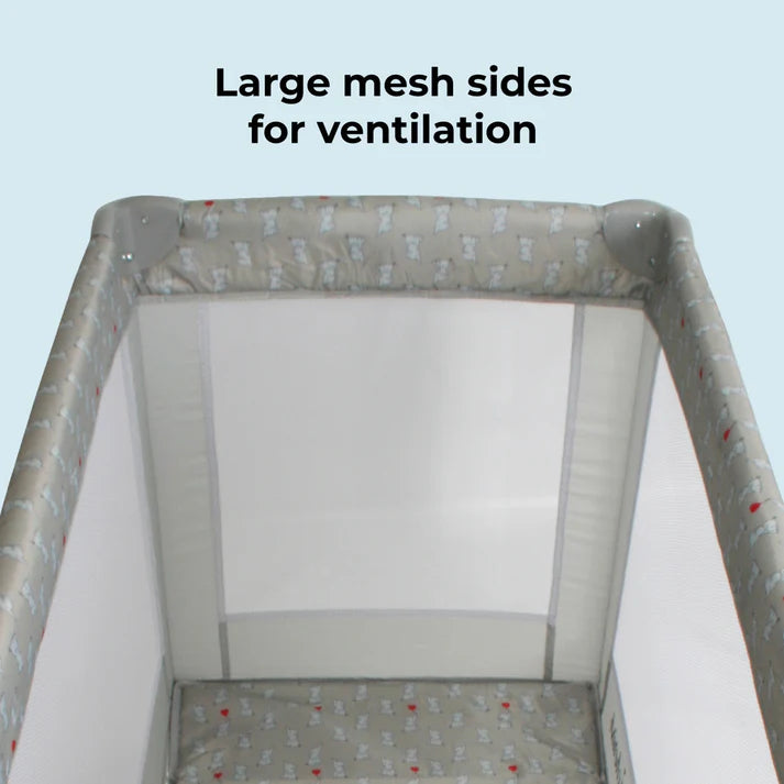 My Babiie Elephants travel cot with large mesh sides for ventilation on a light blue background