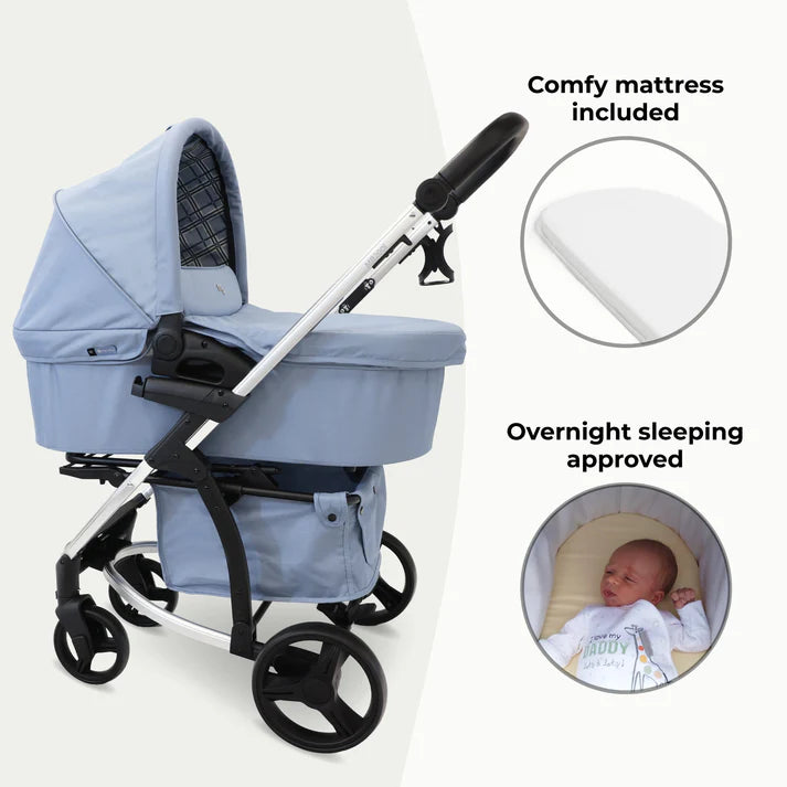 My babiie MB200i 3 in 1 travel system in blue plaid with text indicating features like a comfy mattress and overnight sleeping approval.