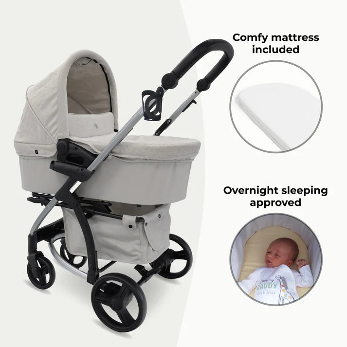 My babiie MB200i 3 in 1 travel system in oatmeal with a baby inside, highlighting features like a comfy mattress and overnight sleeping approval.