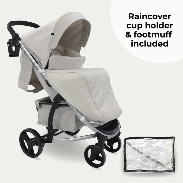 My babiie MB200i 3 in 1 travel system in oatmeal with raincover, cup holder, and footmuff on a white background