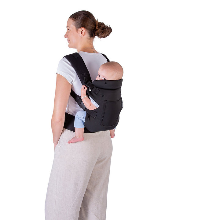 Woman carrying a baby in a Red Kite Ara baby carrier on a white background