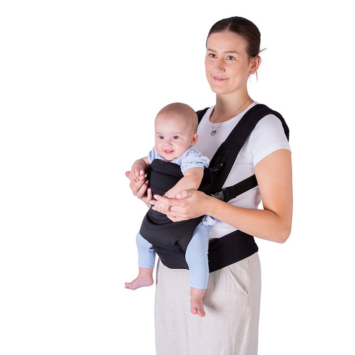 Woman holding a baby in a Red Kite Ara baby carrier against a white background