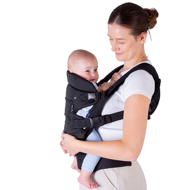 Woman carrying a baby in a Red Kite Ara baby carrier against a white background