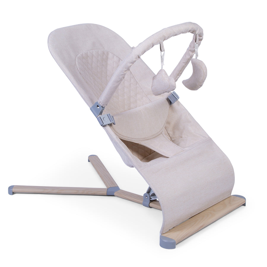 Red Kite Baya Bouncer with beige cushion and wooden base on a white background