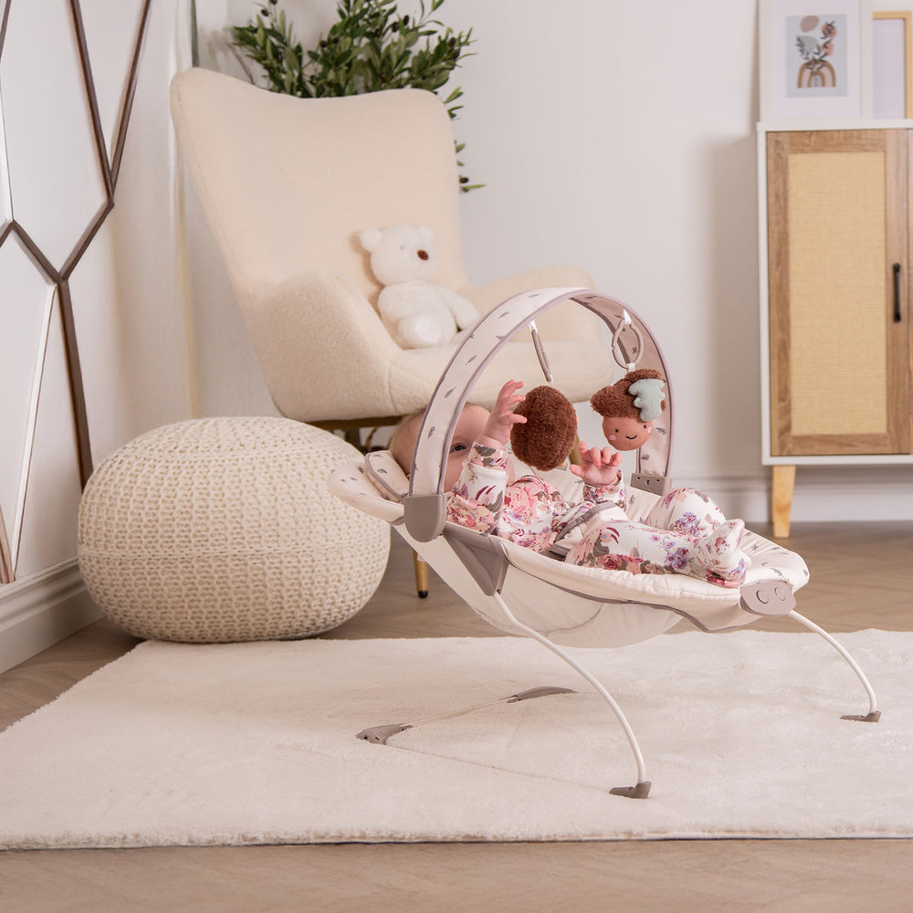 Red Kite Cozy Bounce Baby bouncer with plush toys in a nursery setting