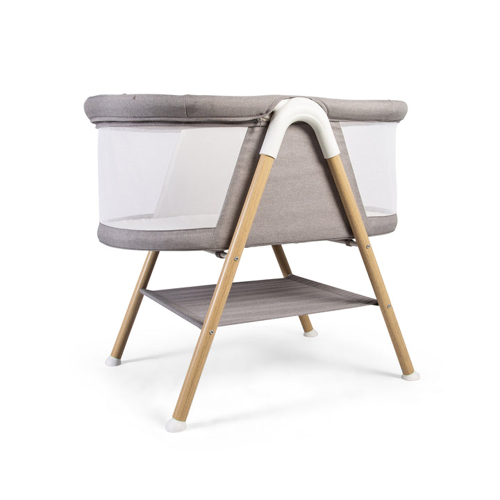 Red Kite Snooze Crib Modern baby crib with wooden legs on a white background