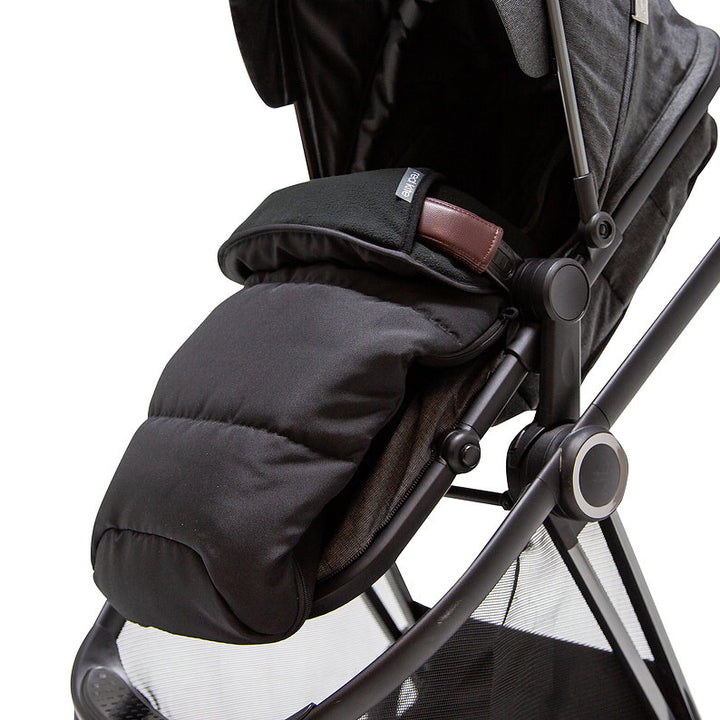 Red Kite Universal Black footmuff attached to a stroller on a white background