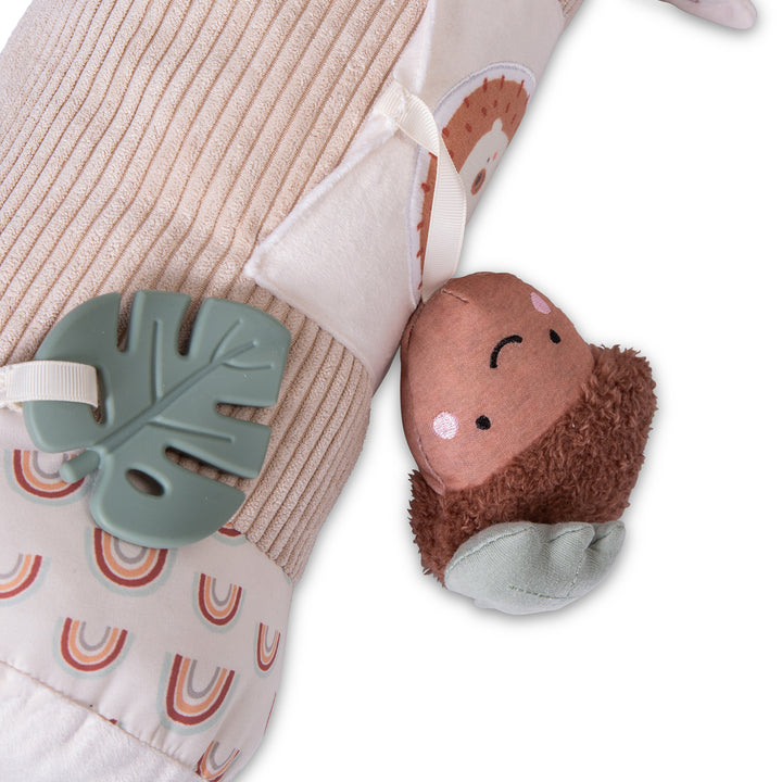 Red Kite Tummy Time Roller Woodland Walks with leaf-shaped teether on a textured surface with rainbow pattern