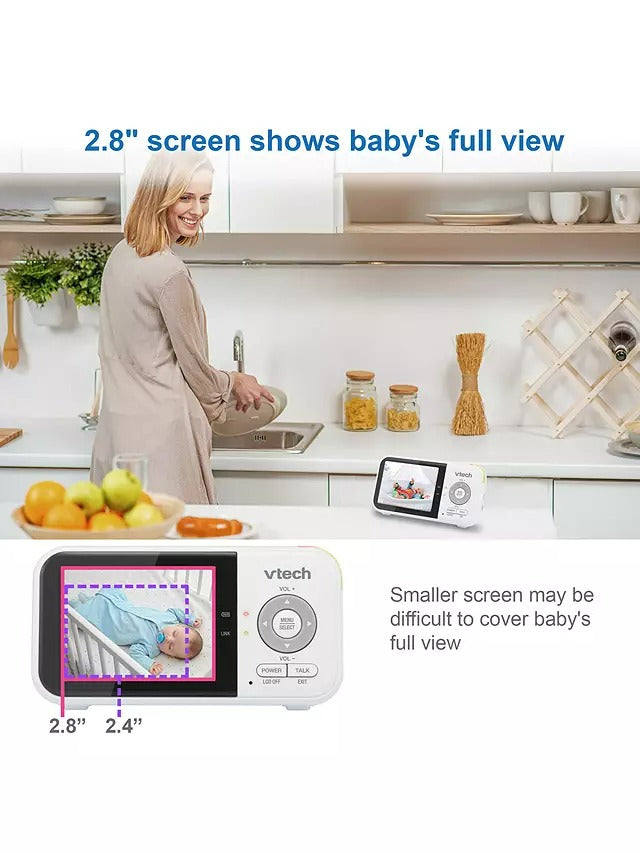 Woman in a kitchen with a VTech baby monitor displaying a smaller screen, with text about screen size.